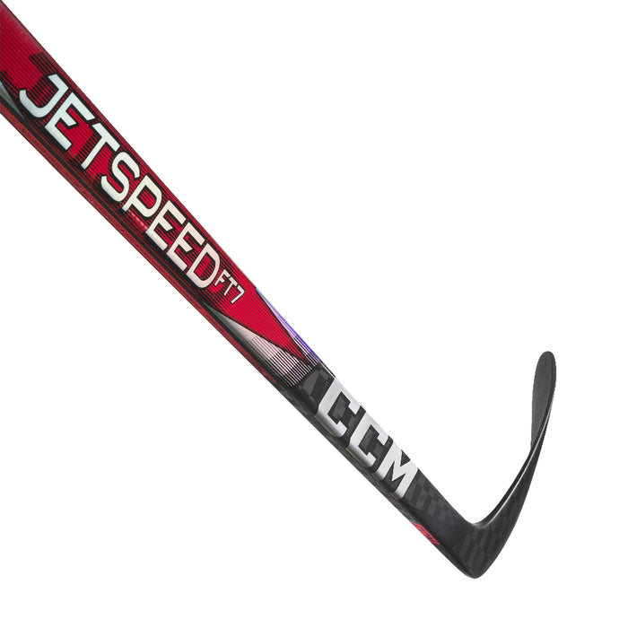 black hockey stick with red mid-section