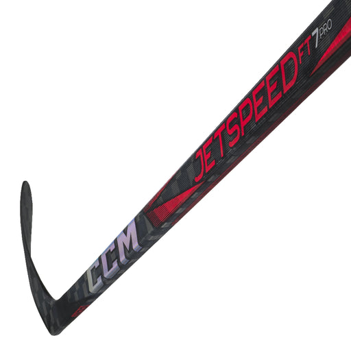 black ccm hockey stick with red writing and details
