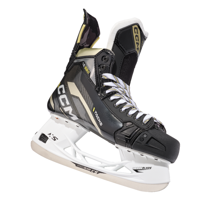 Black skates with gold accents, white laces and black lining