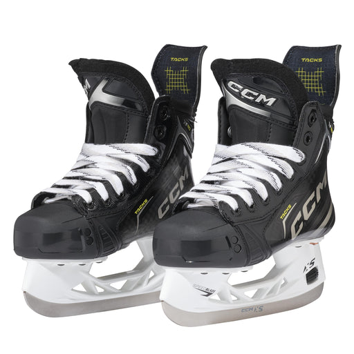 Black skates with gold accents, white laces and black lining