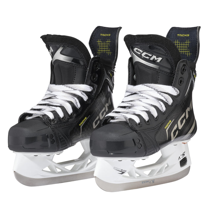 Black skates with gold accents, white laces and black lining