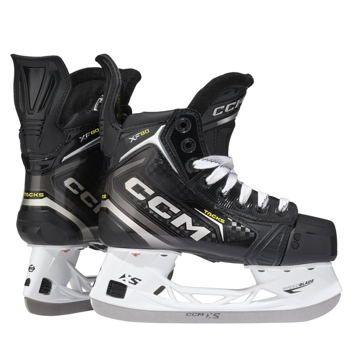 Black skates with gold accents, white laces and black lining