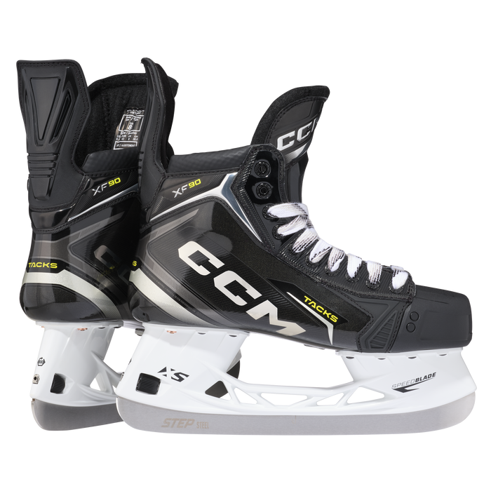 Black skates with gold accents, white laces and black lining
