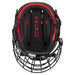 black helmet with red padding and black cage