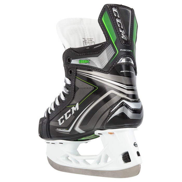 Black skates, with small green features. White laces and black lining