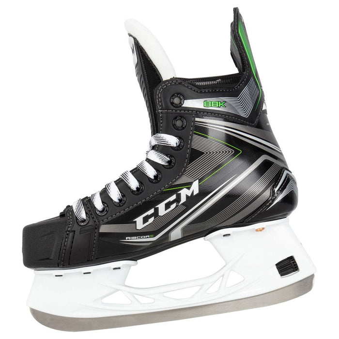Black skates, with small green features. White laces and black lining