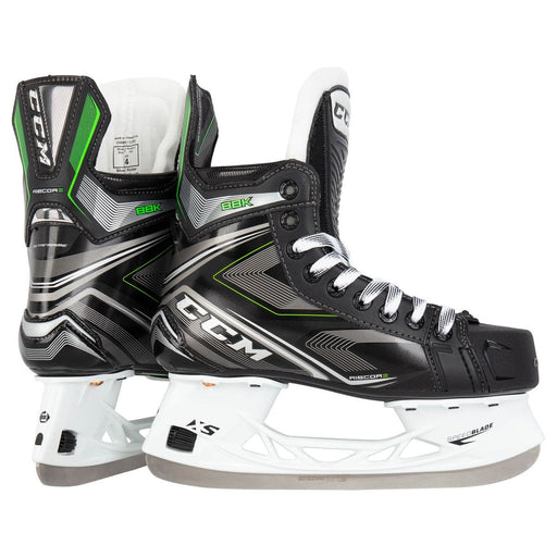 Black skates, with small green features. White laces and black lining