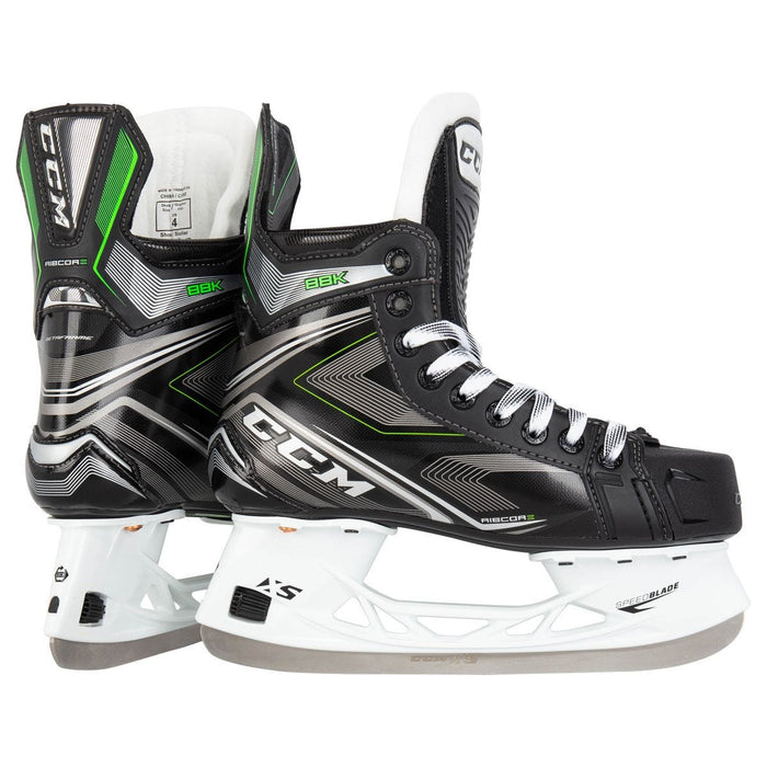 Black skates, with small green features. White laces and black lining