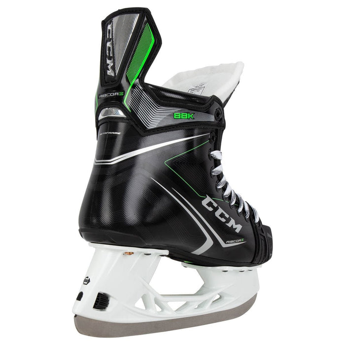 Black skates, with small green features. White laces and black lining