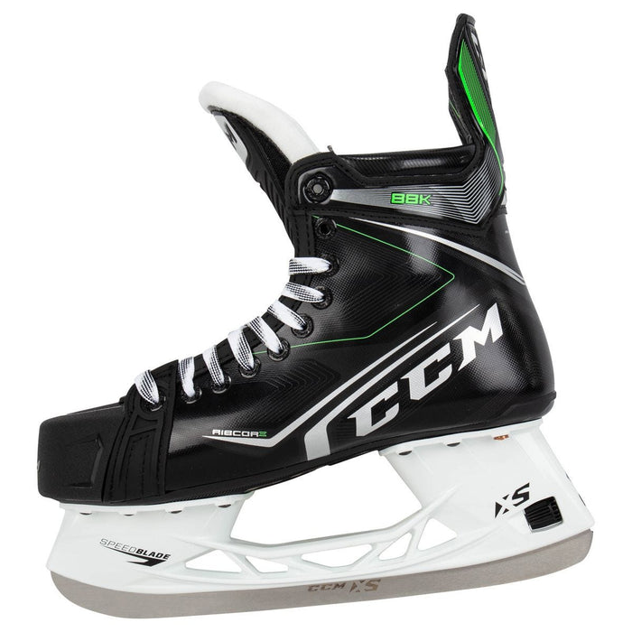 Black skates, with small green features. White laces and black lining