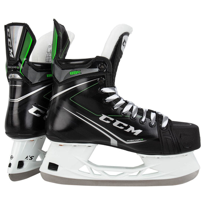 Black skates, with small green features. White laces and black lining
