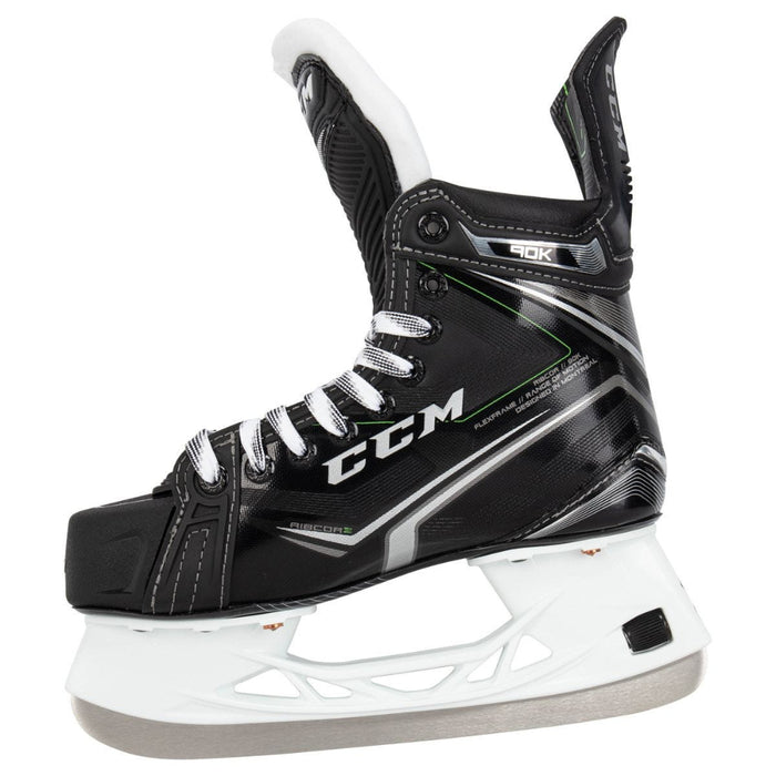 Black skates, with small green features. White laces and black lining