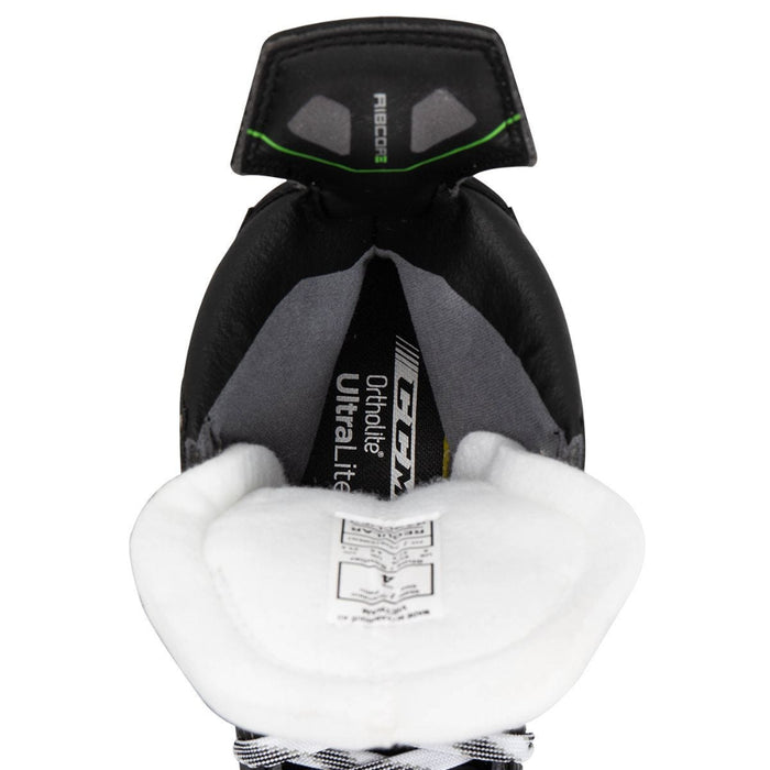 Black skates, with small green features. White laces and black lining