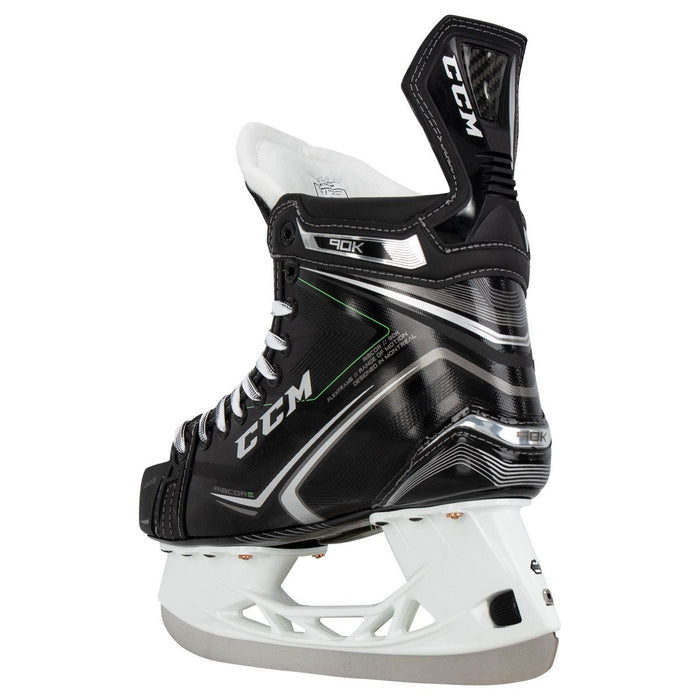 Black skates, with small green features. White laces and black lining