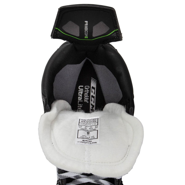 Black skates, with small green features. White laces and black lining