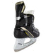 Black skates with gold accents, white laces and yellow lining