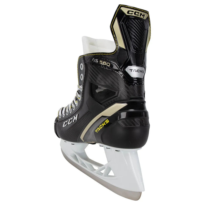 Black skates with gold accents, white laces and yellow lining