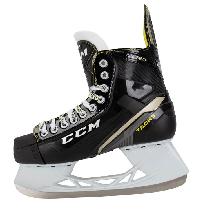 Black skates with gold accents, white laces and yellow lining