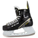 Black skates with gold accents, white laces and yellow lining