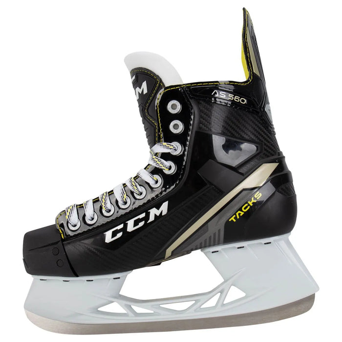 Black skates with gold accents, white laces and yellow lining