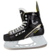 Black skates with gold accents, white laces and yellow lining