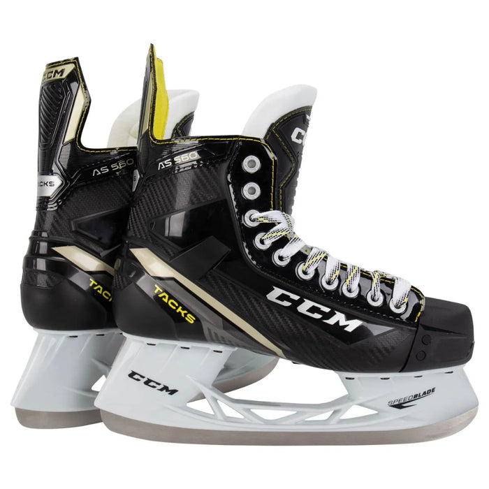 Black skates with gold accents, white laces and yellow lining