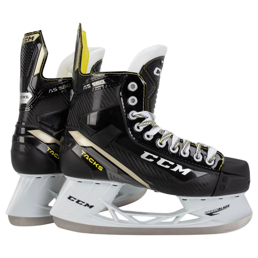 Black skates with gold accents, white laces and yellow lining