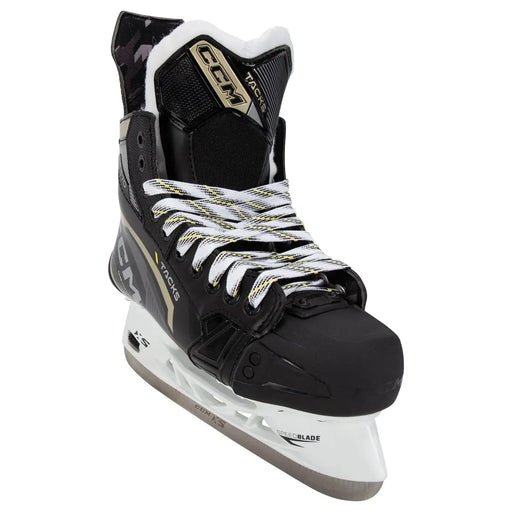Black skates with gold accents, white laces and black lining