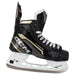 Black skates with gold accents, white laces and black lining