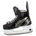 Black skates with gold accents, white laces and black lining