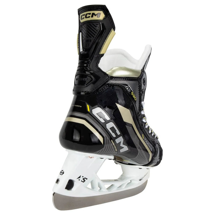 Black skates with gold accents, white laces and black lining