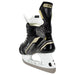 Black skates with gold accents, white laces and black lining