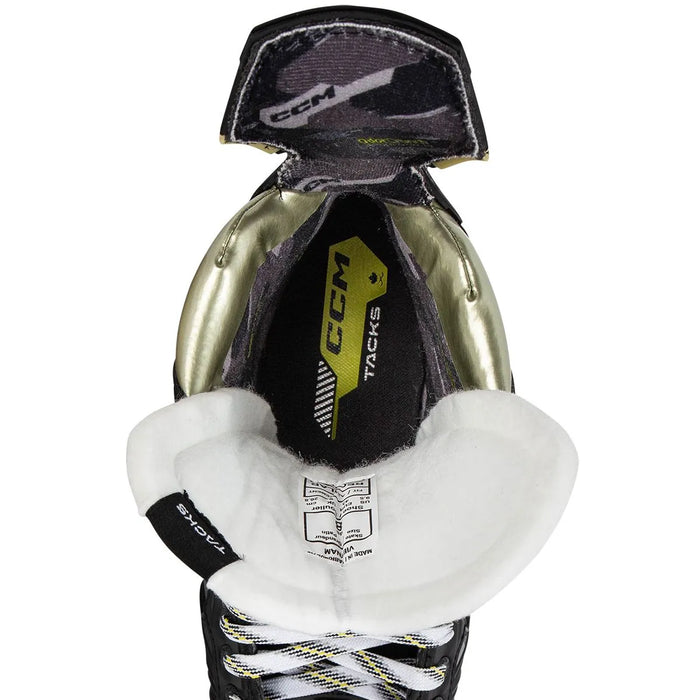 Black skates with gold accents, white laces and black lining